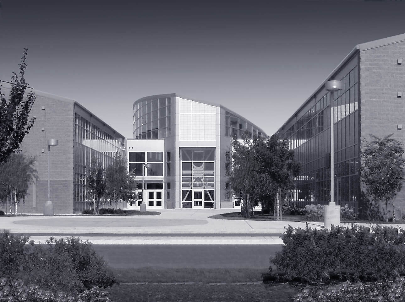 Modern office building with glass facade and symmetrical design.